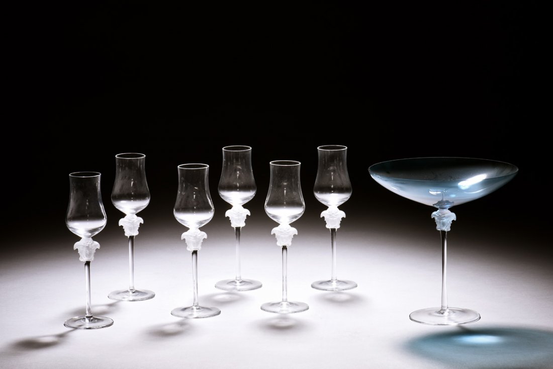 SET OF SEVEN ROSENTHAL FOR VERSACE WINE GLASS CUPS: The set includes seven wine glass cups by Rosenthal of Germany for Versace, six glasses in tall and curved form, one glass with wide and shallow cup, each has a head portrait below the cup, the larger