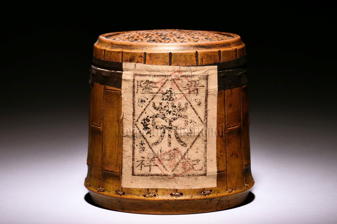 YIXING DUAN CLAY TEA JAR WITH PU ER TEA: Of cylindrical form, the jar shaped similar to a bamboo barrel with detailed bamboo sections and string sections, the character "Cha" incised on one side, the seal "Jing Long Xiang Ji" on the reverse,