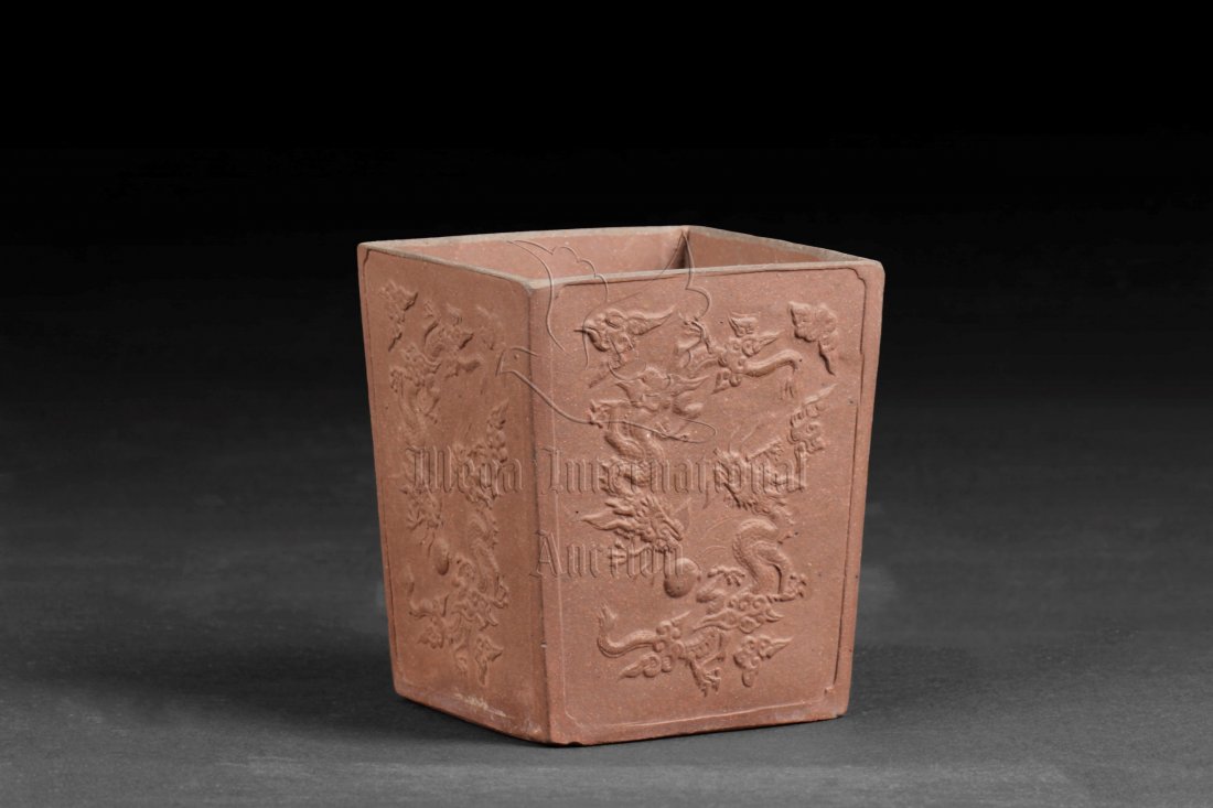 JUGUANGTANG: YIXING RECTANGULAR BRUSH POT: Of tapering rectangular form, the Yixing brush pot with twin dragons chasing flaming pearl motif on each side, bottom bears four character JIGUANGTANGZHI mark. Width: 3 1/2 in (9 cm) Height: 4 1/4 in 