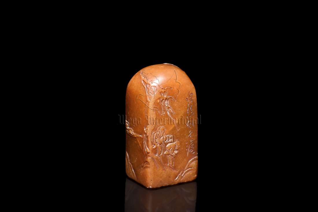 BAI JIAO: SHOUSHAN TIANHUANG SOAPSTONE CARVED 'PEOPLE': The stamp seal carved from Shoushan Tianhuang soapstone, carved on the side with an elder and his attendant walking below the trees towards the foothills, the stone is of orange-brown color tone with 