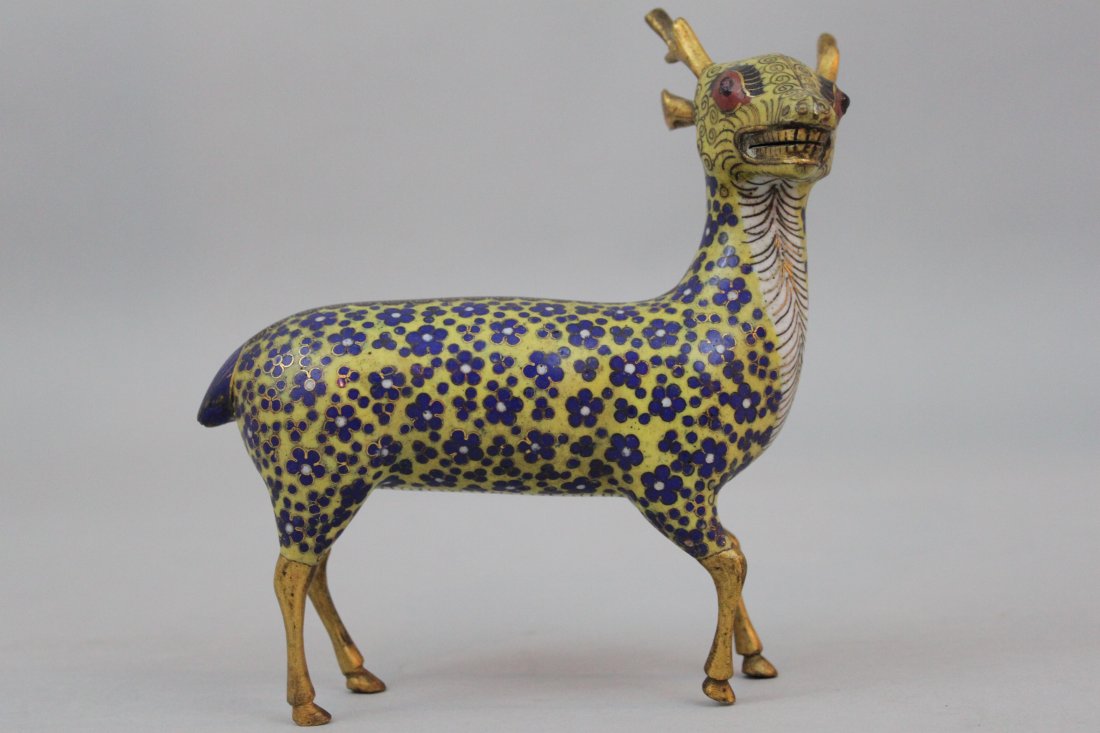 Qing Dynasty Chinese Cloisonne Enamel Model of a Deer: Qing Dynasty Chinese Cloisonne Enamel Model of a Deer. The standing figure decorated with blue and white flowers on a yellow ground. 18th/19th century. 6 3/16" tall; approximately 6" long. For similar