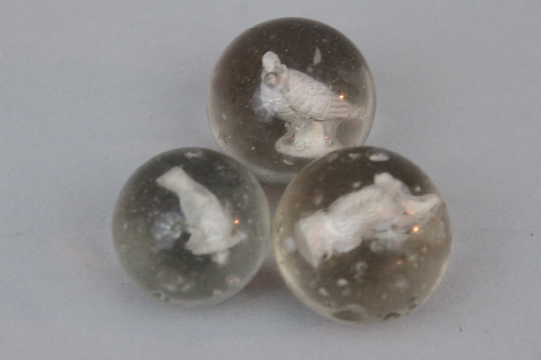 Group of Three Large Sulphide Animal Marbles: Group of Three Large Sulphide Animal Marbles. The first depicting a dog, 1 1/2" diameter, the second depicting a bird, 1 3/4" diameter, the third depicting a squirrel eating a nut, 1 5/8" diameter.