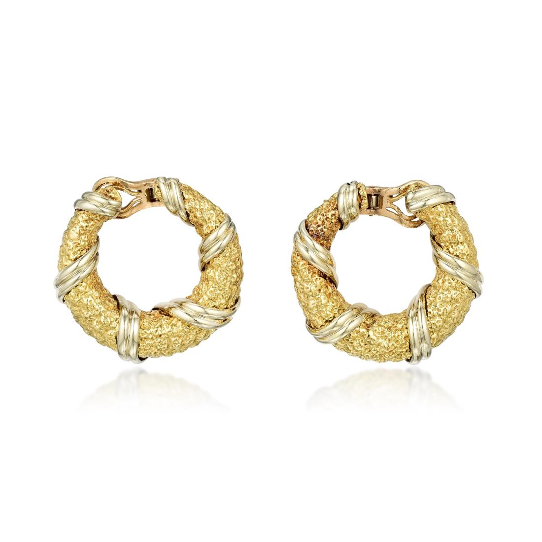 Van Cleef & Arpels Gold Hoop Earclips: Crafted in 18K textured gold; measures 1-1/4 inches; weight 40.45 g. Signed: VCA; Stamped: OR, French assay marks, maker's mark; Numbered: 70 111215