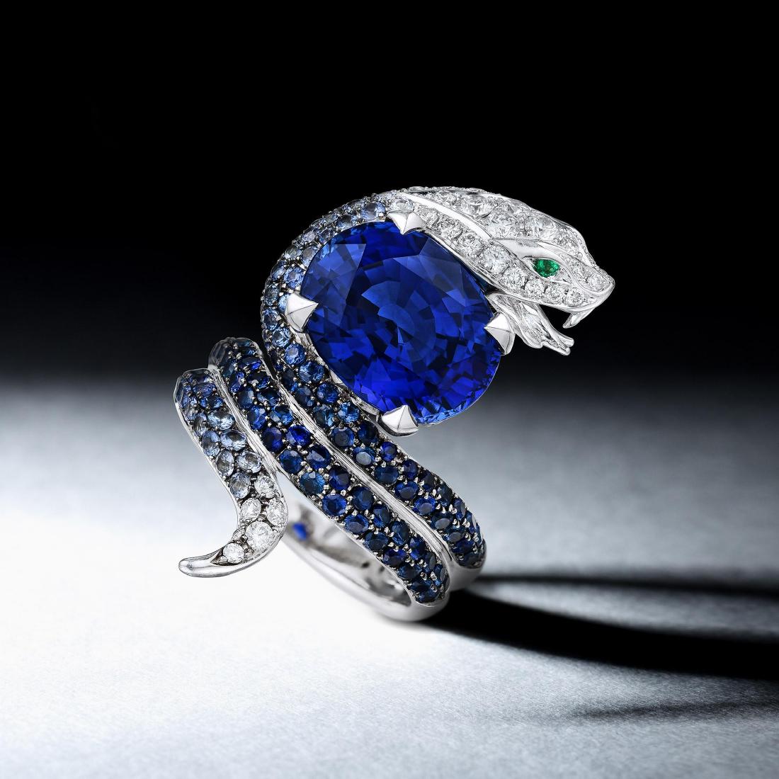 Stephen Webster Ceylon Sapphire Diamond and Emerald: Crafted in 18K white gold; featuring an oval-shaped sapphire weighing 7.87 carats; complemented by 109 round brilliant-cut sapphires weighing a total of approximately 1.75 carats; and 36 round brillia