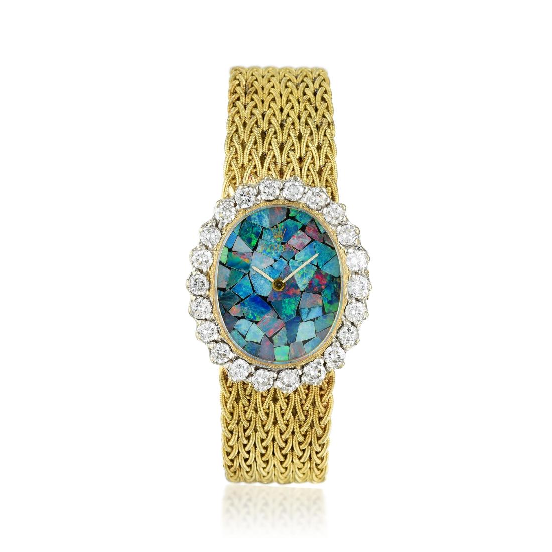 Rolex Ladies Diamond and Opal Watch: Crafted in 14K gold; with a mosaic opal dial and diamond bezel; set with 22 round brilliant-cut diamonds weighing a total of approximately 2.25 carats, most with G-H color VS clarity; powered by a man