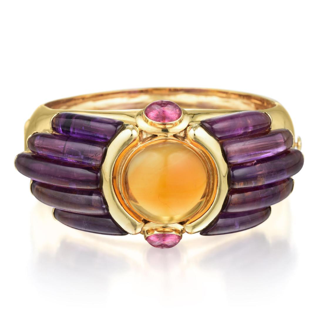 Maz Citrine Amethyst and Pink Tourmaline Bangle: METAL: 14K gold GEMSTONE(S): cabochon citrine approx. 27.00 carats; accented with amethyst and pink tourmaline MEASUREMENTS: 6-3/4 inner circumference, width 1-3/8 inches at widest section WEIGHT: 65.