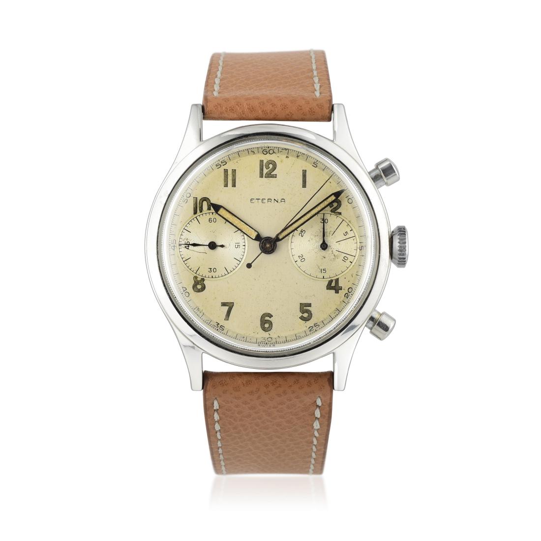 Eterna Oversized Chronograph in Steel: CIRCA: 1950s CASE MATERIAL: Stainless steel CASE DIMENSIONS: 38 mm in diameter DIAL: Opaline white with luminous Arabic hour markers, seconds track in black. BRACELET MATERIAL: Light tan leather strap