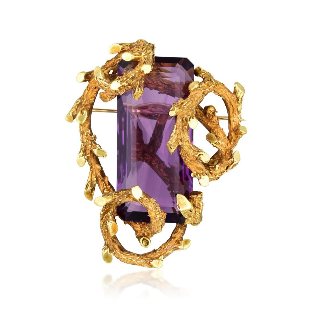 Erwin Pearl Large Amethyst Brooch: METAL: 18K gold GEMSTONE(S): rectangular emerald-cut amethyst approx. 82.00 carats MEASUREMENTS: 2-3/8 x 2 inches WEIGHT: 68.10 g. Signed: E.PEARL; Stamped: 18K, 3M2619 PROPERTY OF A LADY