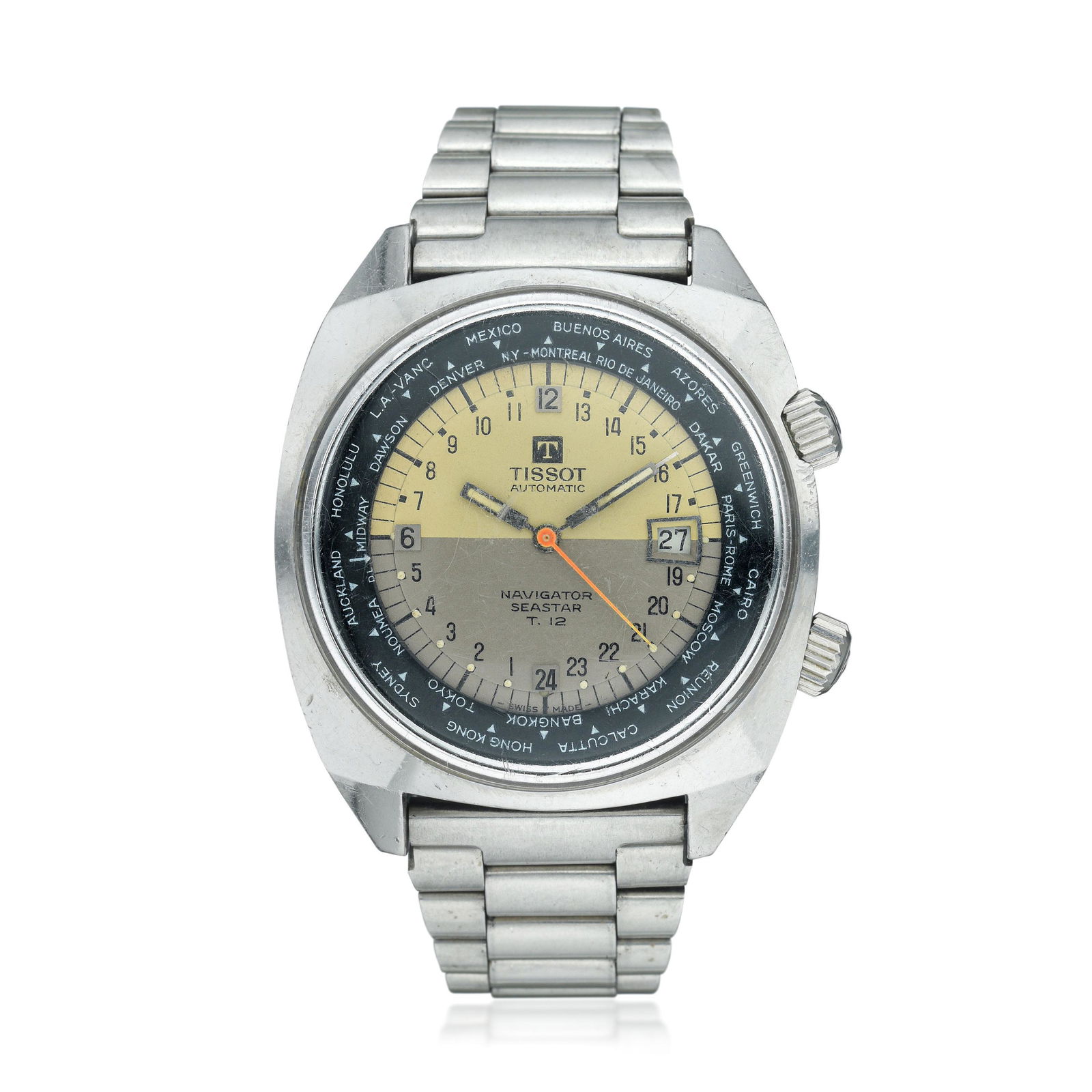 Tissot T 12 Navigator Seastar 24-Hour World Time in: CIRCA: 1970s REF.: 44566-2 CASE MATERIAL: Stainless steel CASE DIMENSIONS: 42 mm wide x 49 mm lug-to-lug DIAL: Pale yellow and taupe representing AM and PM with applied hour markers, date aperture at