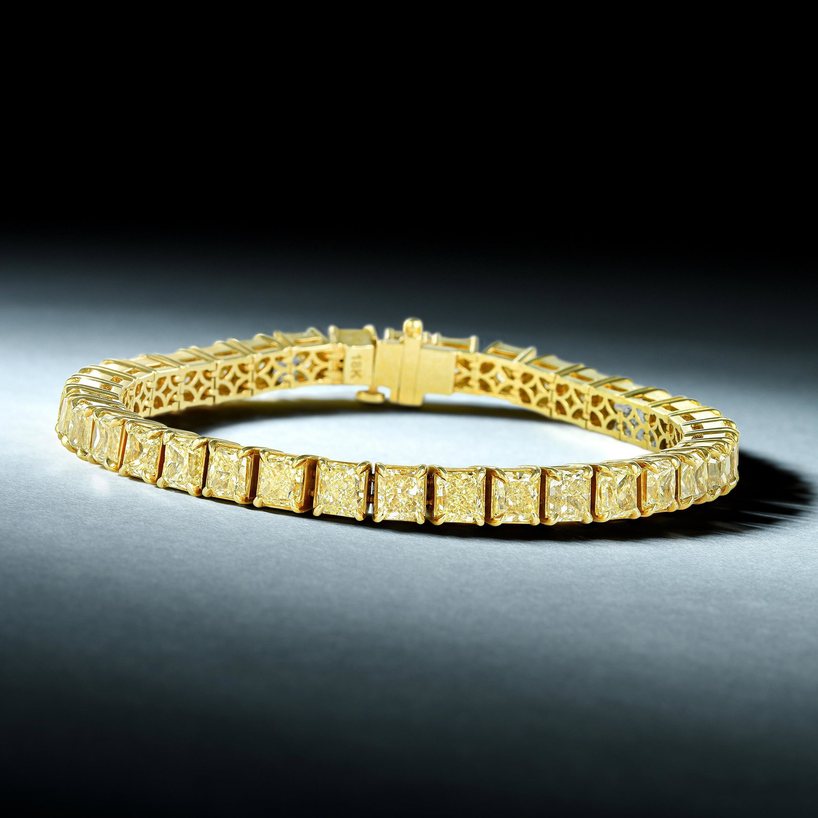 Radiant-Cut Diamond Tennis Bracelet: View a video of this lot here: https://youtu.be/Uxcg88TWfLc Crafted in 18K gold; set with radiant-cut diamonds, weighing a total of approximately 18.00 carats, most with Fancy Yellow color (not tested