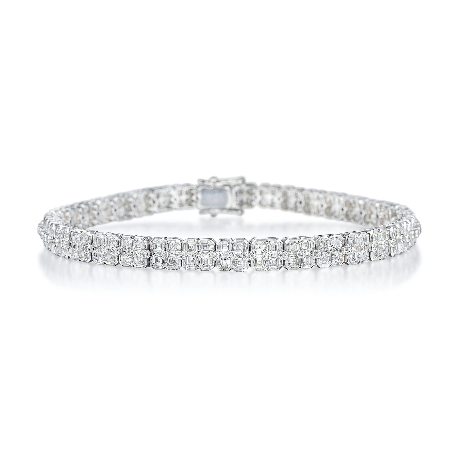 Asscher-Cut Diamond Tennis Bracelet: Crafted in 18K white gold; set with cut-cornered step- and round brilliant-cut diamonds, weighing a total of approximately 6.75 carats, most with G-H color and VS-I1 clarity; measures 7-1/8 inches, wi