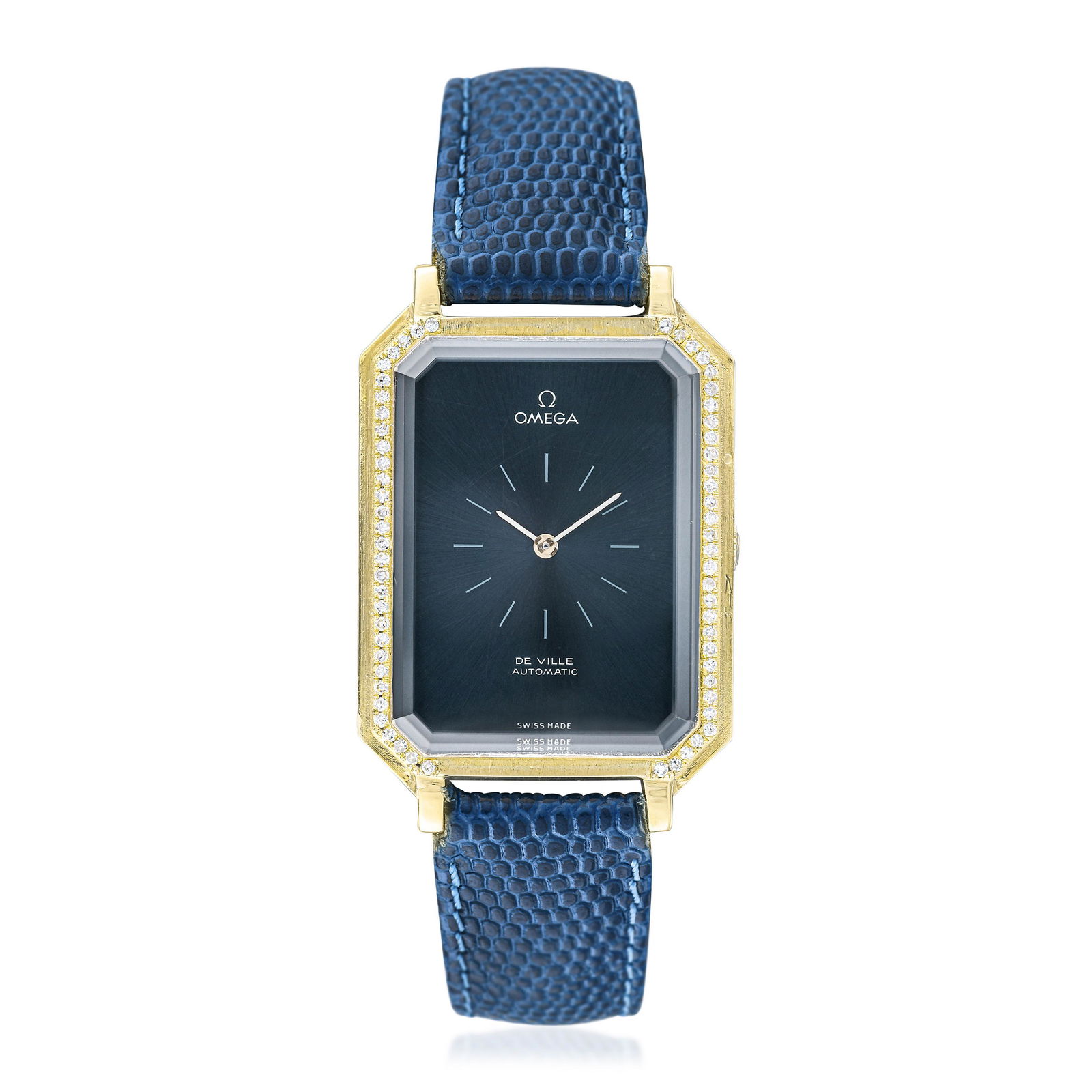 Omega DeVille by Andrew Grima in 18K Gold: CIRCA: 1971 SERIAL NUMBER: 33947223 REF.: 8326 CASE MATERIAL: 18K yellow gold CASE DIMENSIONS: 26.5 mm wide x 40 mm lug-to-lug DIAL: Sunburst dial in blue-grey with white printed hour markers BRACELET