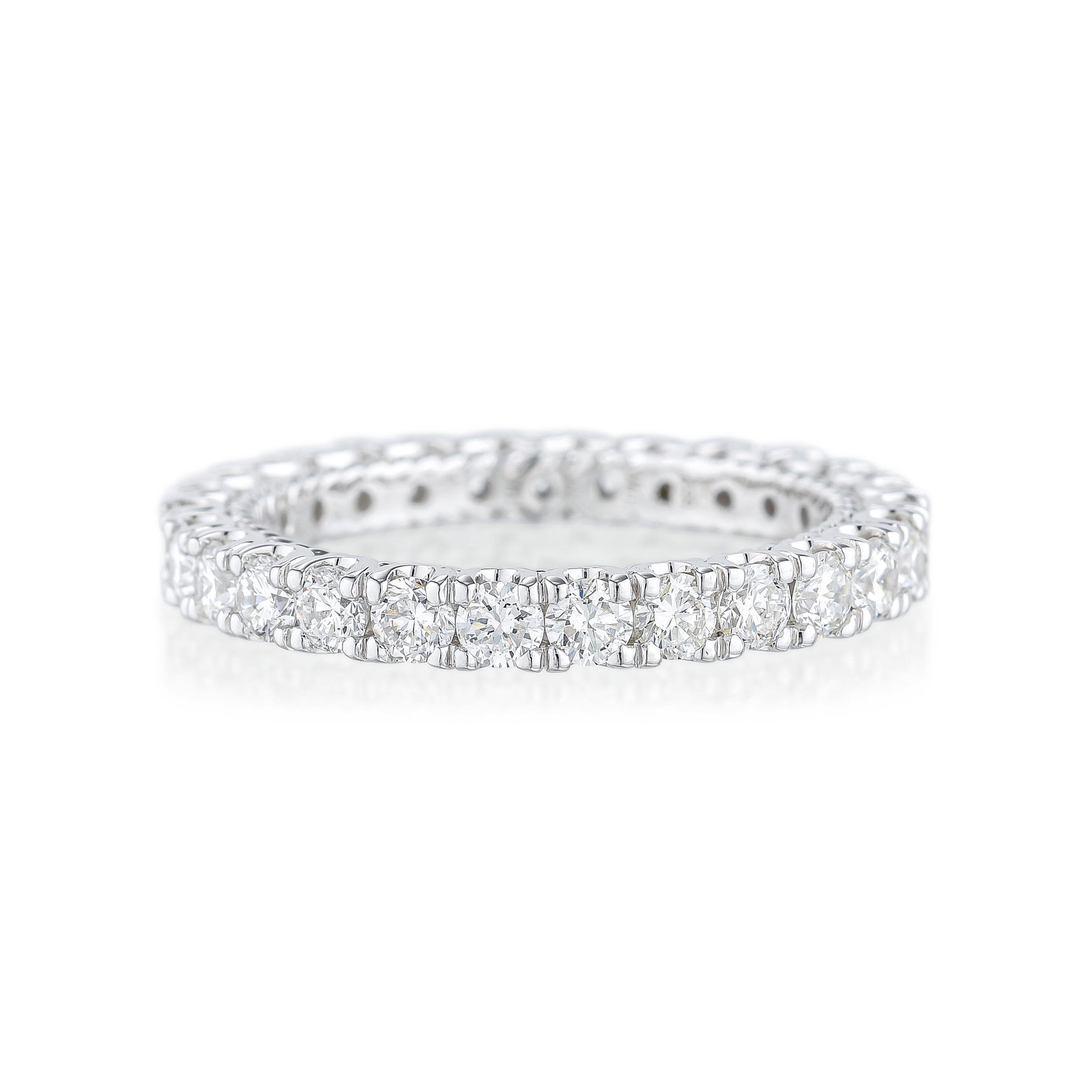 Diamond Eternity Band: METAL: 18K white gold GEMSTONE(S): round brilliant cut diamonds approx. 1.57 carats total, most G-H/SI1-SI2 RING SIZE: 6 WEIGHT: 3.20 g. Stamped: 18K, 750, DW, 68