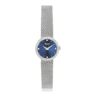 Chopard Ladies' Watch in 18K White Gold: Summary of Key CharacteristicsCIRCA: 1980s CASE MATERIAL: 18K white gold DIAL: Sunburst blue dial with applied hour markers. Diamond hour markers at "12," "3," "6," and "9" BRACELET MATERIAL: