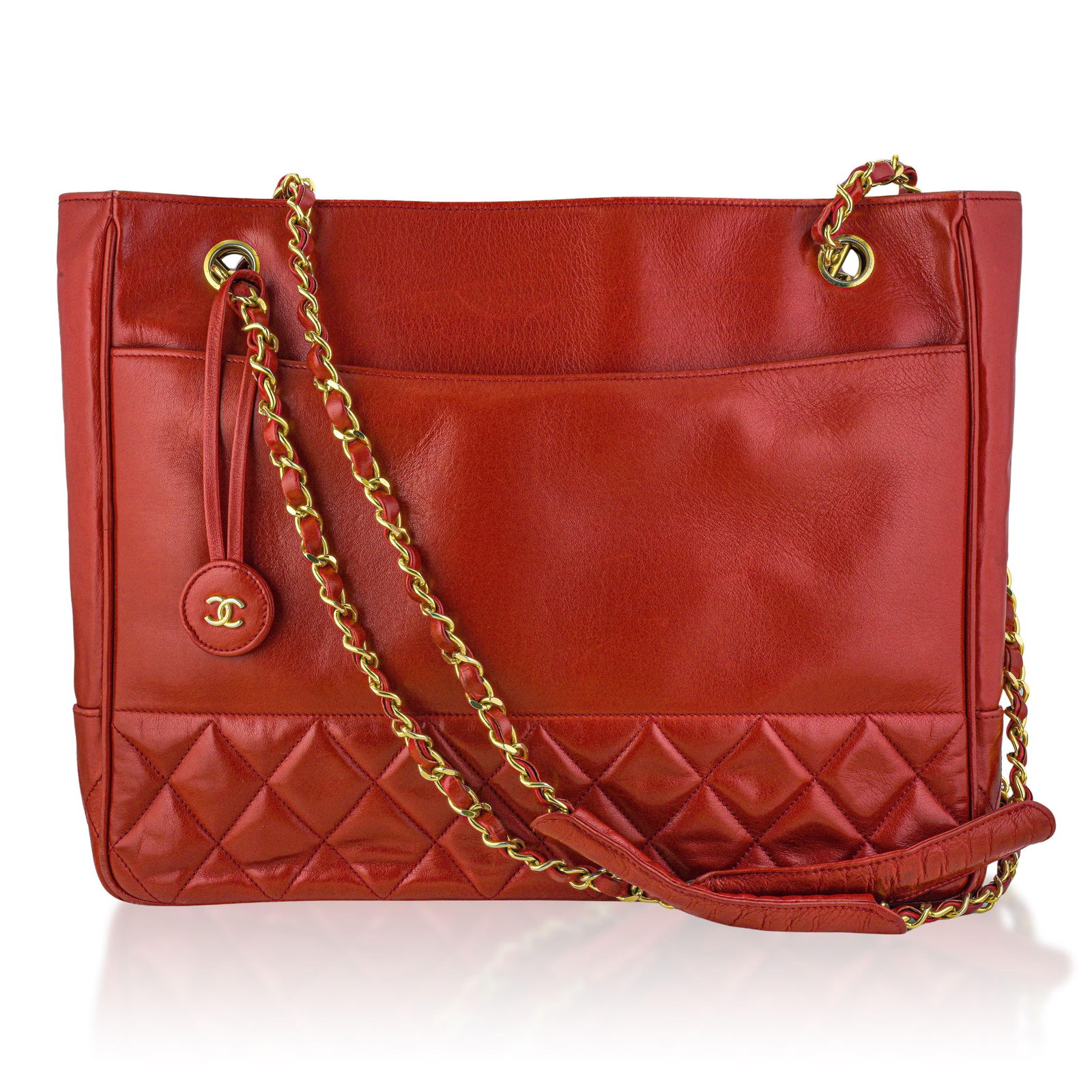 Chanel Matelasse Chain Tote in Red Lambskin: Crafted from supple red lambskin leather and finished with classic gold-tone chain hardware, it exemplifies Chanel's timeless elegance and iconic quilted design. The structured yet refined silhouette