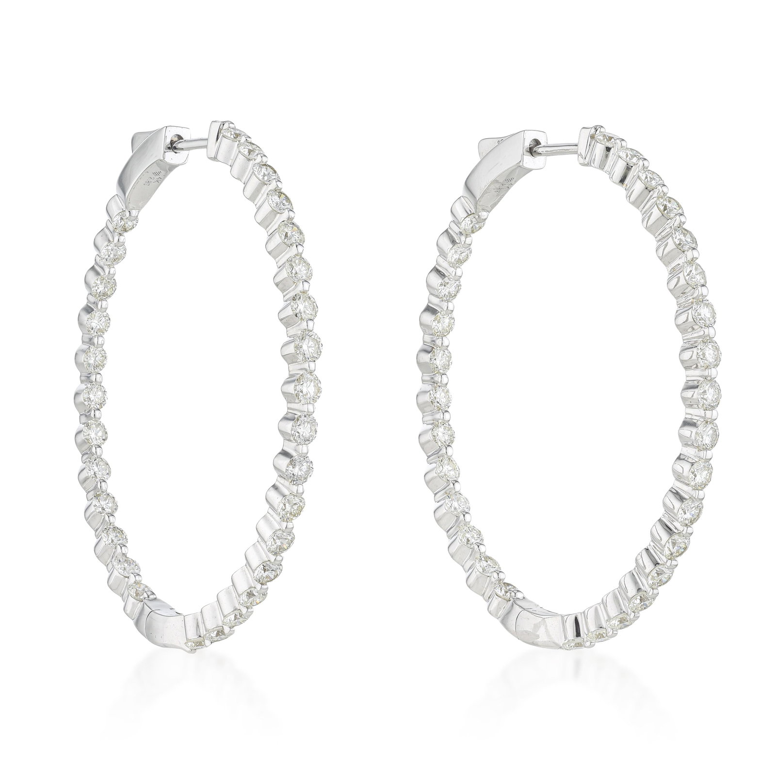 Oval Inside Out Hoop Earrings (Approx. 2.89 CTW): Summary of Key Characteristics • Metal: 14K white gold • Gemstone(s): Round brilliant cut diamonds approx. 2.89 carats total, most I-J/I1 • Measurements: 42mm x 35mm •