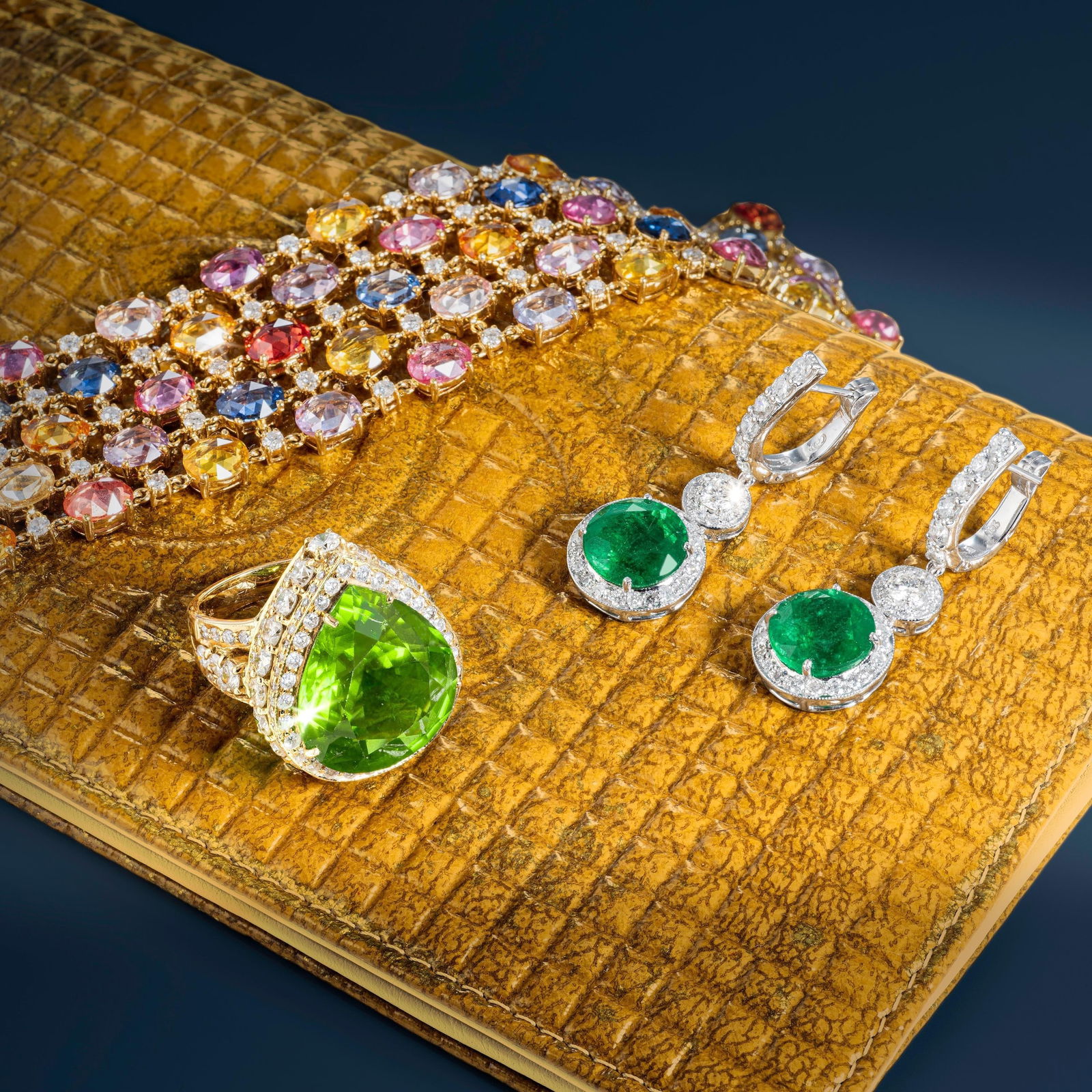 Multicolor Sapphire and Diamond Wide Bracelet: Approximately 70.94 carats of multicolor sapphires with 4.04 carats of diamonds in an 18K yellow gold wide bracelet: the sapphires span the full spectrum from blue through green to yellow and orange,