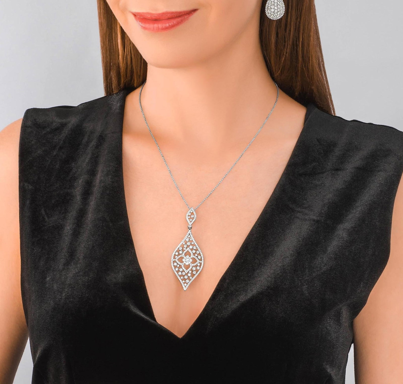 Diamond Flower Motif Pendant Necklace: ESTIMATED RETAIL PRICE: $7,750* *This is the estimated value a piece of similar quality, craftsmanship, and characteristics could command at retail. Exuding both elegance and boldness, the