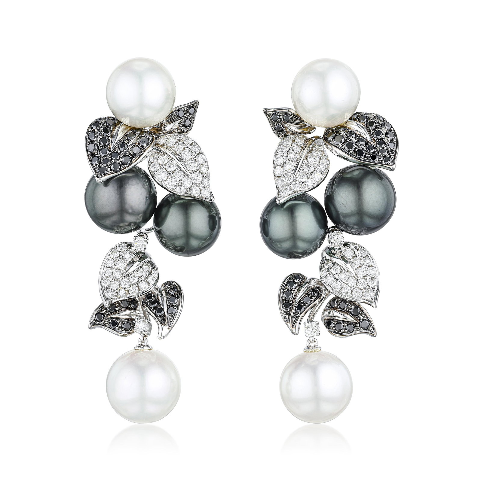 Pearl and Diamond Leaf Earrings: ESTIMATED RETAIL PRICE: $24,000* *This is the estimated value a piece of similar quality, craftsmanship, and characteristics could command at retail. The interplay of white and black diamonds in this