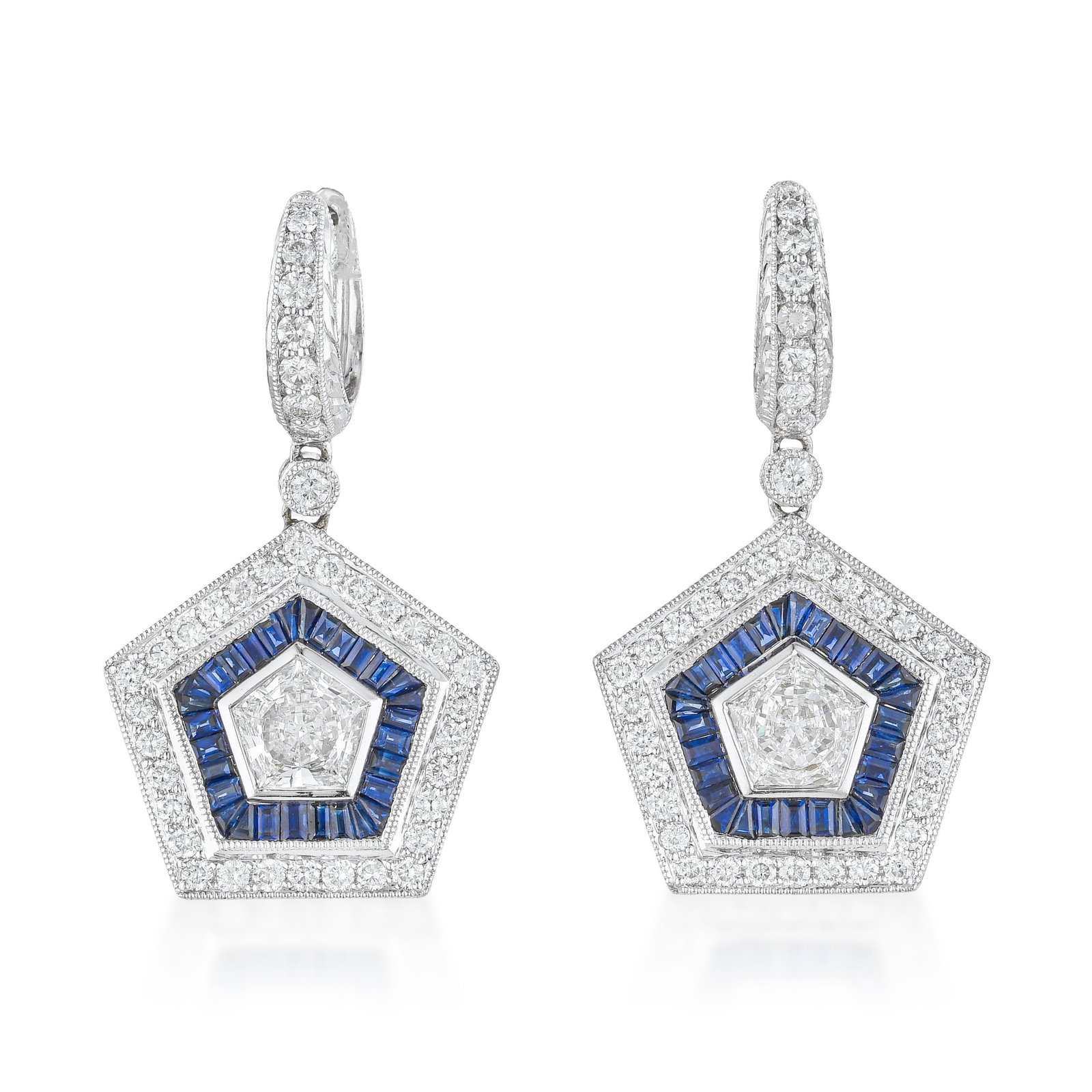 Sapphire and Diamond Drop Earrings: ESTIMATED RETAIL PRICE: $25,000* *This is the estimated value a piece of similar quality, craftsmanship, and characteristics could command at retail. The pentagon-cut diamonds anchoring these earrings