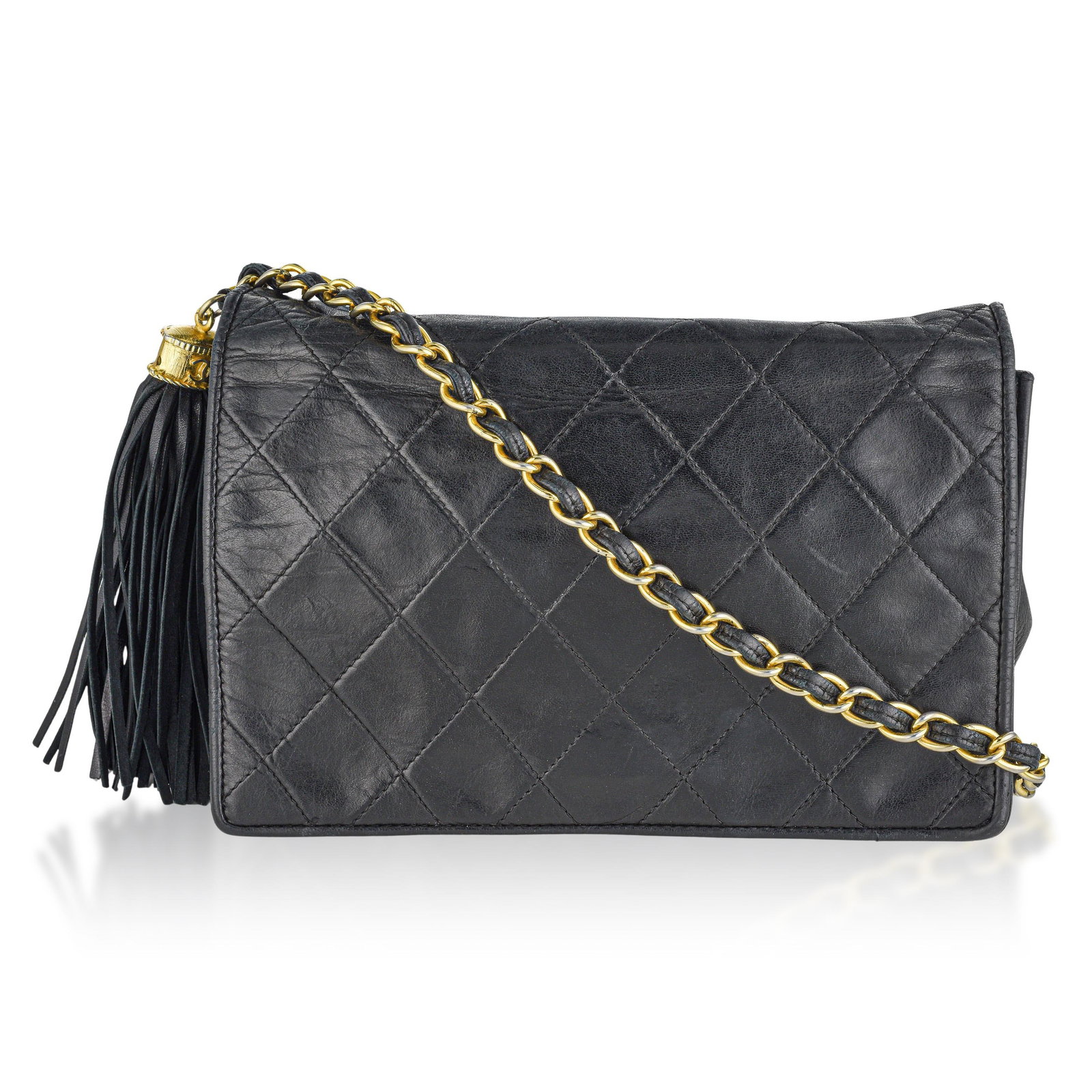 Chanel Classique Leather Crossbody Bag: This striking Chanel Vintage Single Flap Fringe Chain Shoulder Bag is crafted from supple black lambskin leather with iconic vintage Chanel aesthetic. The bag is finished with classic gold-tone