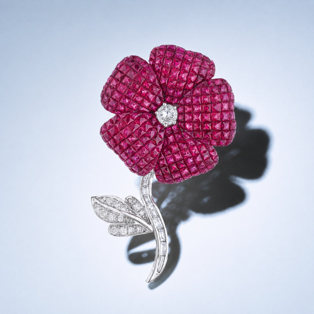Ruby Invisible-Set and Diamond Flower Pin: ESTIMATED RETAIL PRICE: $10,000 * *This is the estimated value a piece of similar quality, craftsmanship, and characteristics could command at retail. Invisible setting in ruby demands more from the
