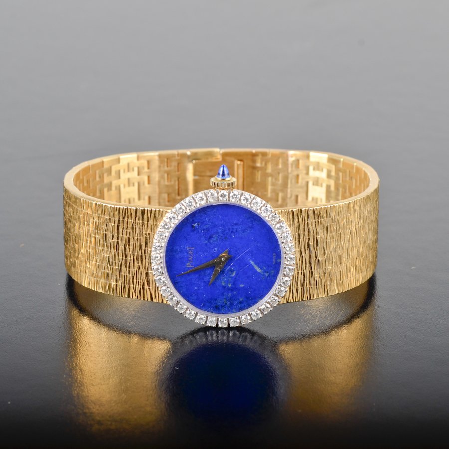Piaget 18k diamond lapis dial lady's watch: Piaget 18k diamond lapis dial lady's watch. 58.9 grams, 6.5 inches. 1"diameter