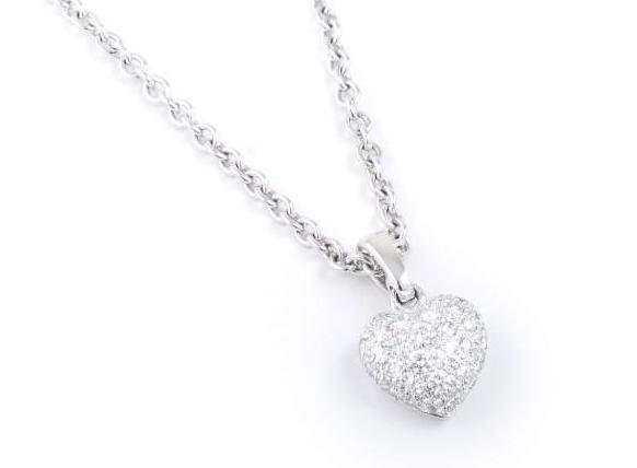 A Diamond Heart Pendant Necklace, by Cartier: Set with 37 round brilliant-cut pavé-set diamonds weighing approximately 0.7 carat, mounted in 18K white gold; signed 750 Cartier DR 6967 on necklace plaque; signed Cartier 750 ND9272 on pendant; pen