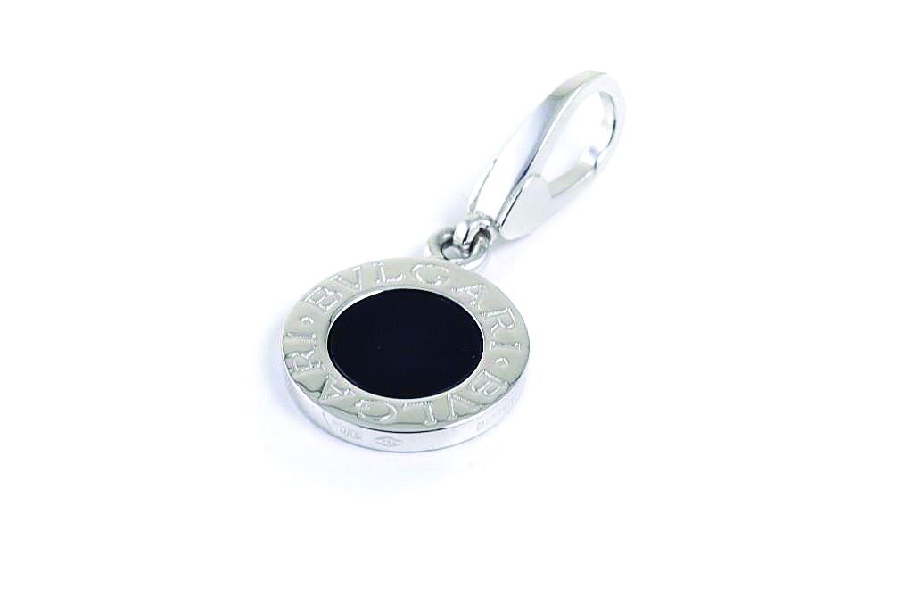 An Onyx Gold Pendant, by Bulgari: Crafted using 18K white gold; signed Bvlgari 750, 2337AL, Made in Italy; pendant length 1 inch; weight 3.5g.