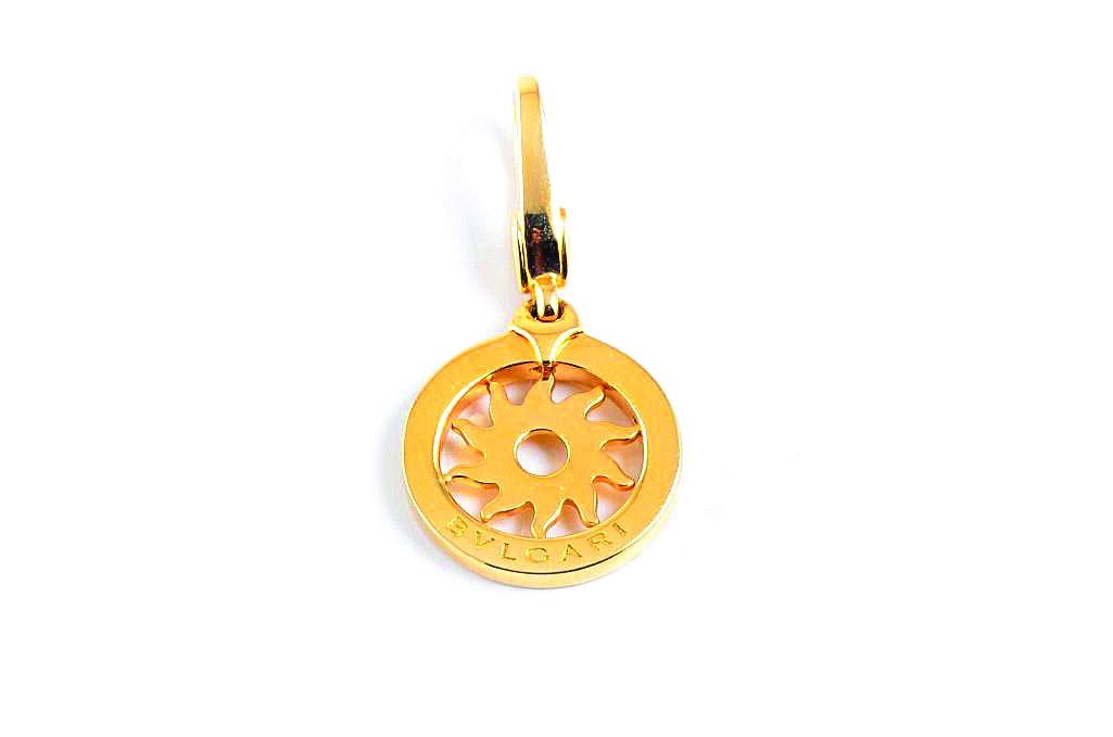A Gold Pendant, by Bulgari: Designed as an 18K yellow gold sunburst pendant; signed Bvlgari Made in Italy 1970AL 750; pendant length 1 inch; weight 3.6g.