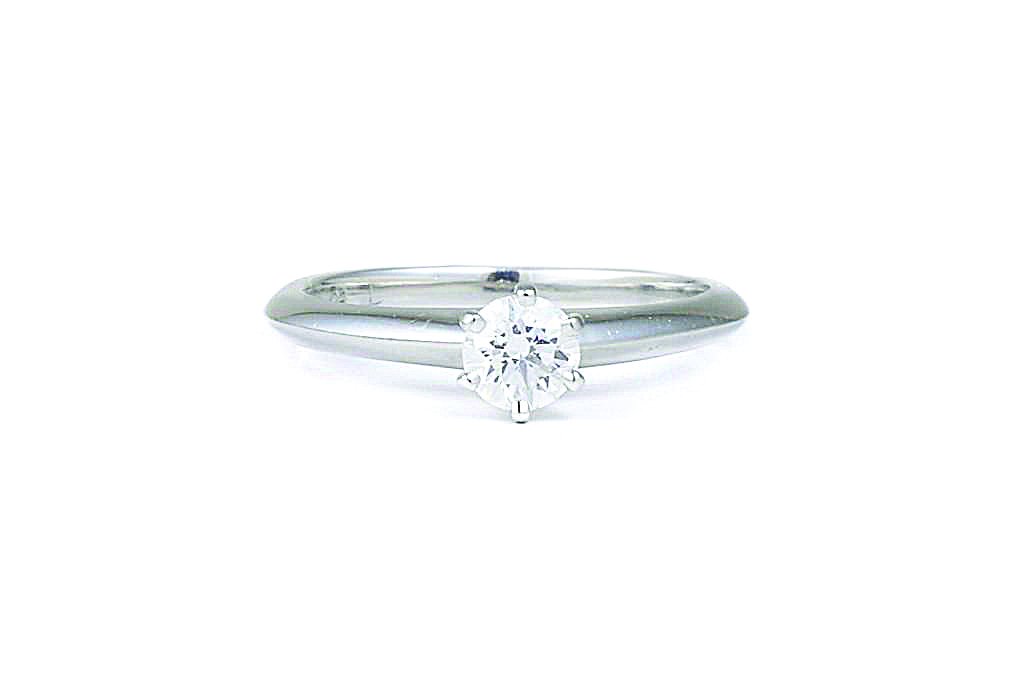 A Platinum Diamond Engagement Ring, by Tiffany & Co.: Set with a solitaire round brilliant-cut diamond, weighing 0.29 carats; mounted in platinum; signed Tiffany&Co. PT 950 .29 carats J57451; ring size 4-1/4; weight 3g.