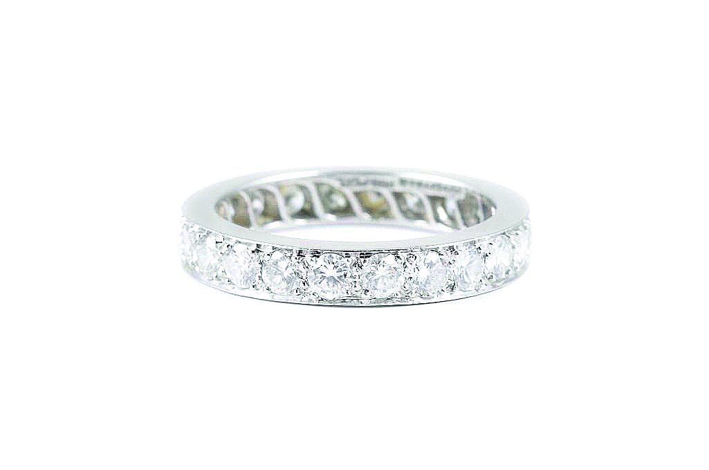 A Platinum Diamond Wedding Band, by Tiffany & Co.: Platinum Tiffany diamond wedding band. 22 round cut diamonds weigh approximately 2.5 carats, F-G color, VS clarity. Stamped Tiffany & Co. IRID. Plat. Ring size 9 1/4, weight 7.9g.