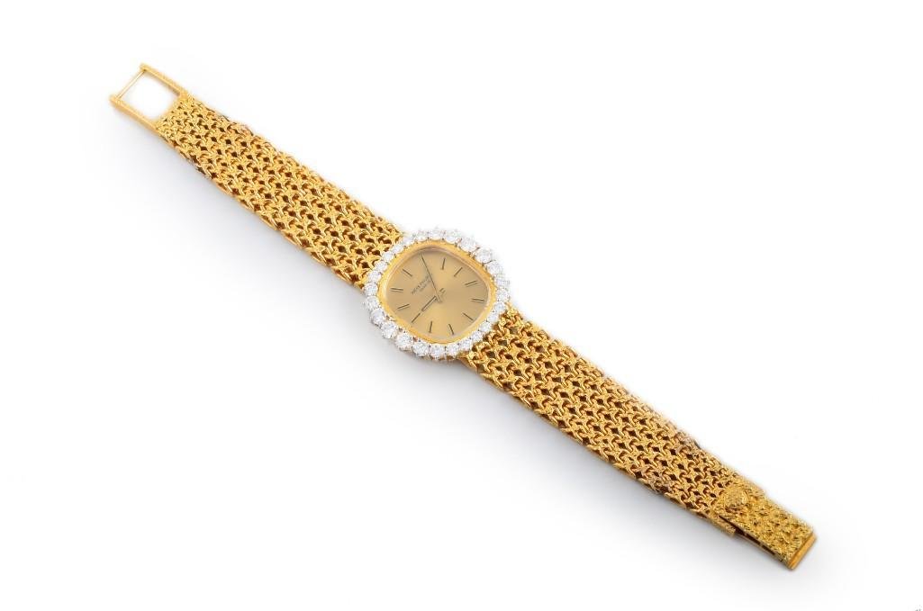 A Ladies Gold Diamond Watch, by Patek Philippe: Designed by Patek Philippe as an Ellipse wristwatch, using 18K yellow gold, with 20 graduated round brilliant-cut diamonds, weighing approximately 2 carats; 18-jewel, rhodium plated, fausses-cotes dec
