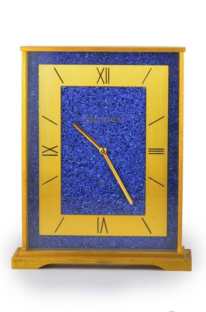 A Lapis Desk Clock, by Jaeger LeCoultre: Jaeger Le Coutre desk clock. Base metal. Signed Swiss 530. Measures approximately 4-1/8 inches x 5-5/8 inches.