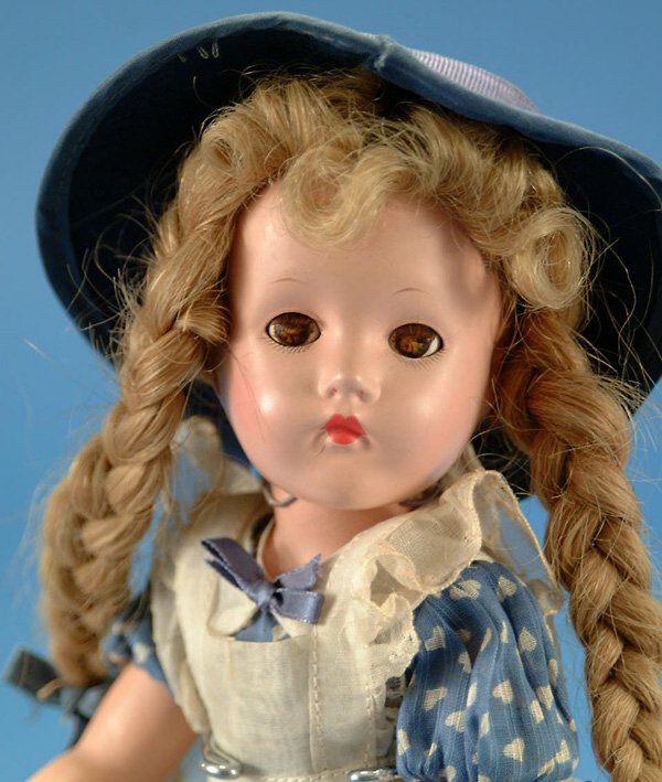 13" Effanbee Suzanne, all comp, br. sl. eyes, orig: 13" Effanbee Suzanne, all comp, br. sl. eyes, orig blonde human hair braided wig, magic hands, orig blue cotton outfit w/organdy pinafore, very minor surface crazing, flaking to hands, eyes crazing, V