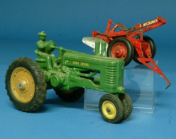 Arcade John Deere Tractor, cast aluminum, L 7", lo: Arcade John Deere Tractor, cast aluminum, L 7", lot incl pressed steel plow, G, (est. $50 - $100)
