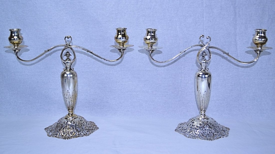 Sterling & Welch Sterling Silver Art Nouveau Candelabra: This pair of sterling silver candelabra is a wonderful example of the Art Nouveau style in the Edwardian period. The bases are dainty with a pierced design of flowers and scrollwork, while the body ha