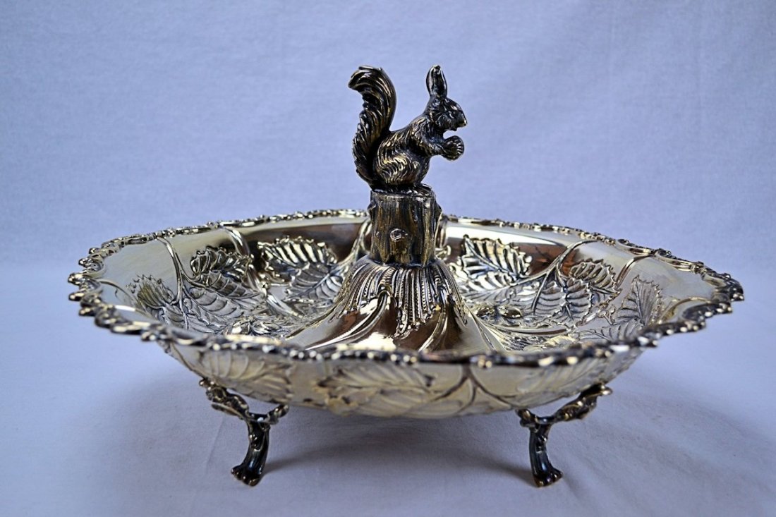 Sterling Silver Nut Dish: This is a wonderful and unusual sterling silver nut dish. Surmounted in the center of the bowl, on a tree stump, sits a squirrel casually nibbling on a nut, the rest of the bowl has been sweetly decor