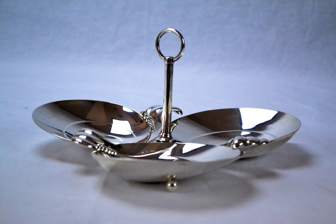 Tiffany & Co. Sterling Silver Art Modern Serving Dish: This is a chic and unusual 1950’s Art Modern Tiffany & Co. sterling silver serving dish, consisting of three bowls with a central ring handle. Each bowl has a simple but elegant design and rests on 