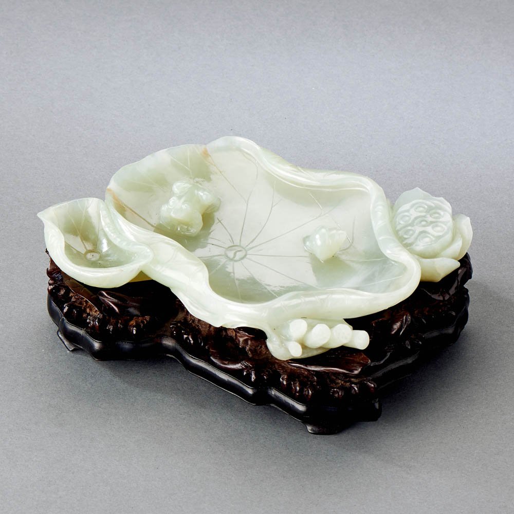 A CHINESE PALE CELADON LOTUS LEAF BRUSH WASHER: QING DYNASTY (1644-1911) A CHINESE PALE CELADON LOTUS LEAF BRUSH WASHER Christie's New York, 22nd July 2014, lot 354. 清 青白玉荷葉水洗 __ 來ě