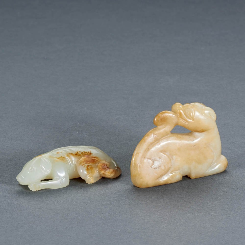 TWO CHINESE WHITE JADE RECUMBENT DOGS: MING DYNASTY (1368-1644) TWO CHINESE WHITE JADE RECUMBENT DOGS 明 白玉臥犬兩件 The largest: L 5.2 cm. (2 1/8 in.)
