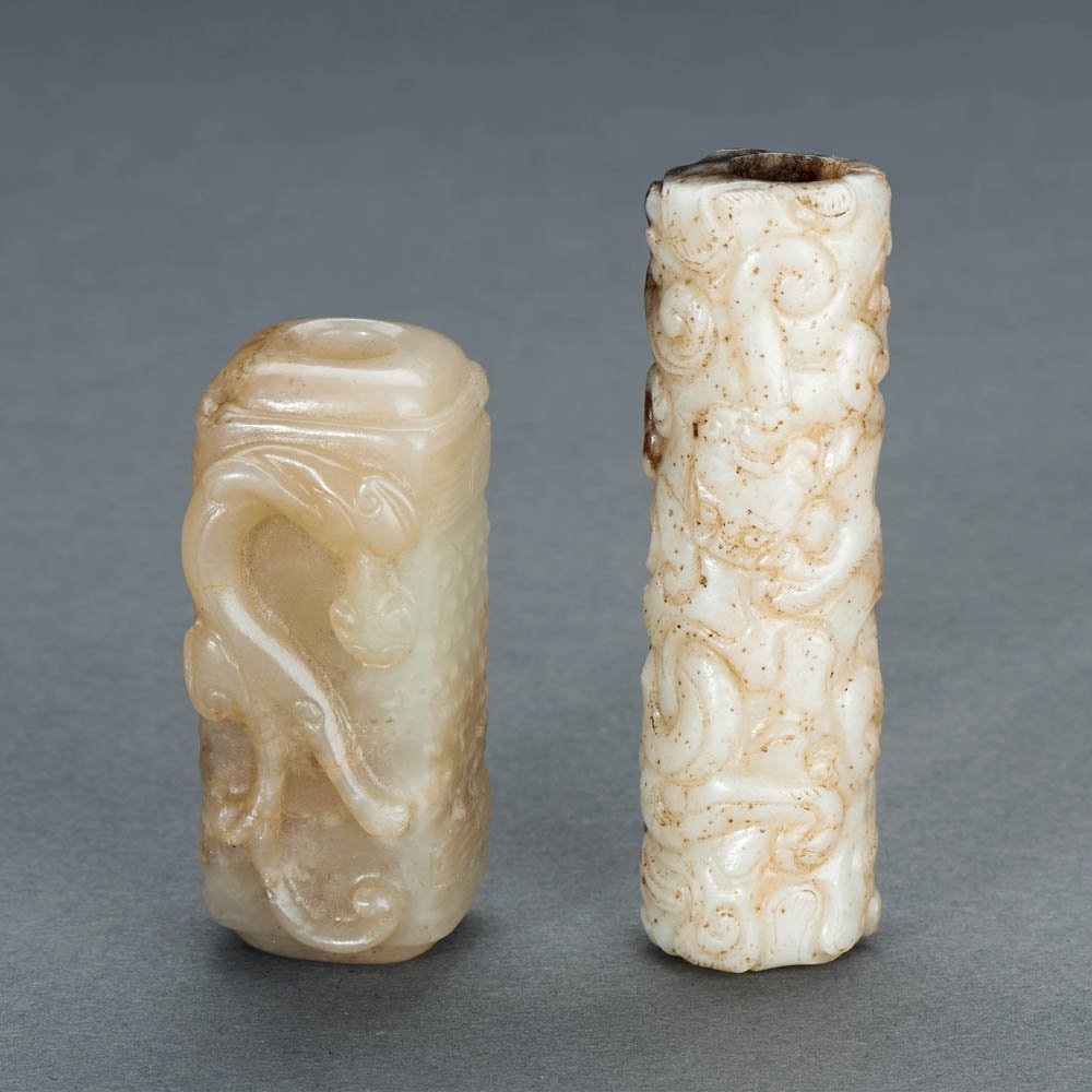 TWO CHINESE WHITE JADE CHI DRAGON PENDANTS, LEZI: MING DYNASTY (1368-1644) TWO CHINESE WHITE JADE CHI DRAGON PENDANTS, LEZI 明 白玉雕「螭龍」紋勒子兩件 The largest: L 6.4 c