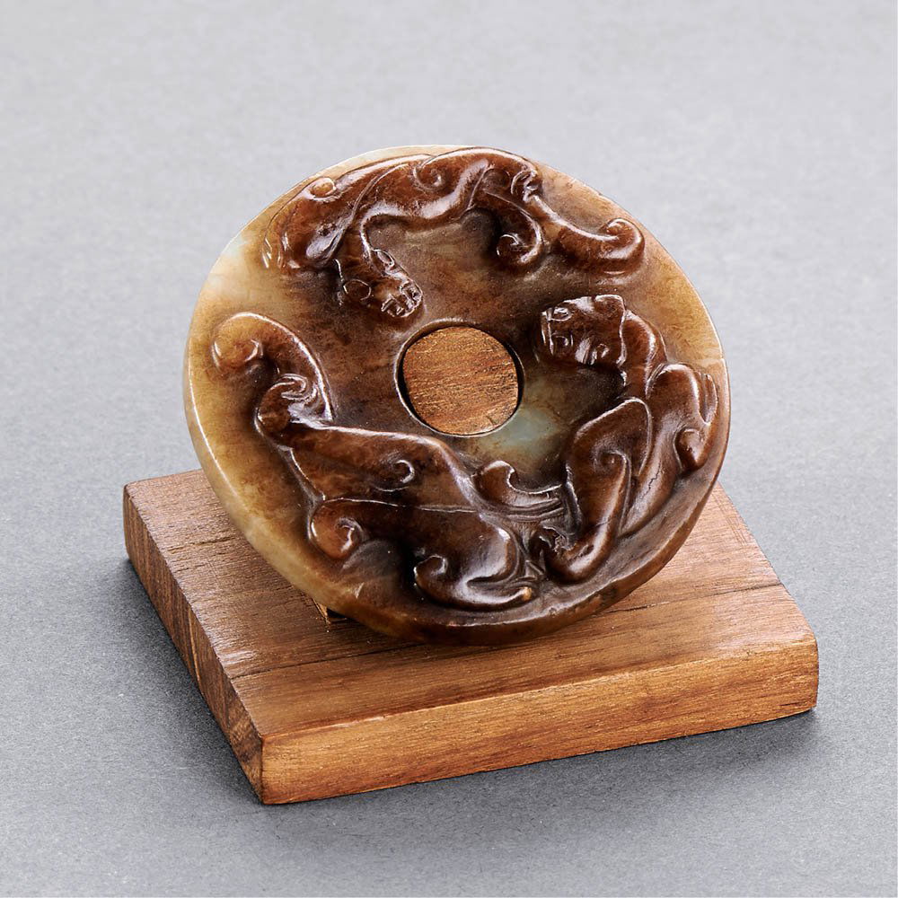 A CHINESE WHITE AND RUSSET JADE DRAGON DISC, BI (1 of 3)