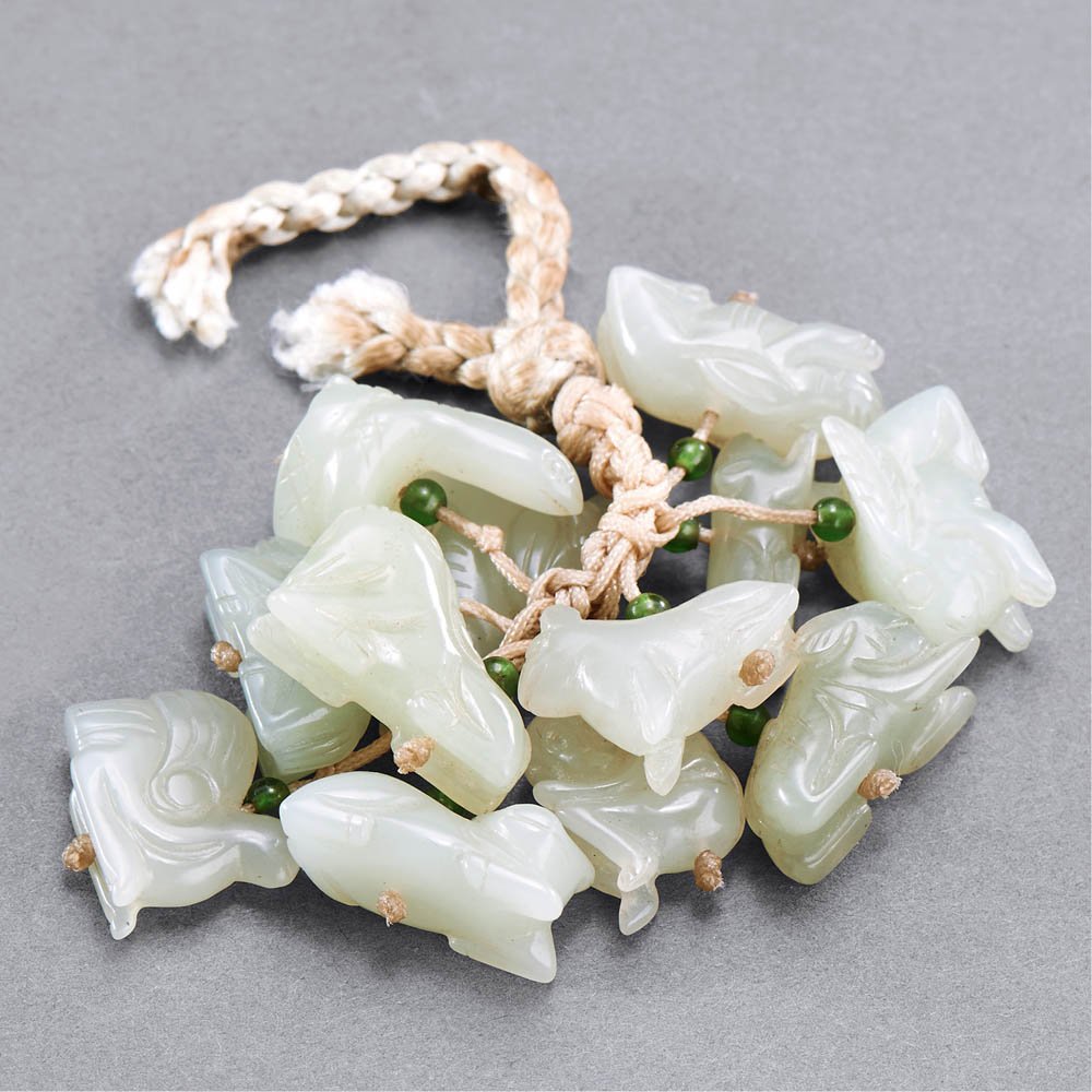 A GROUP OF CHINESE TWELVE WHITE JADE PENDANTS (1 of 1)