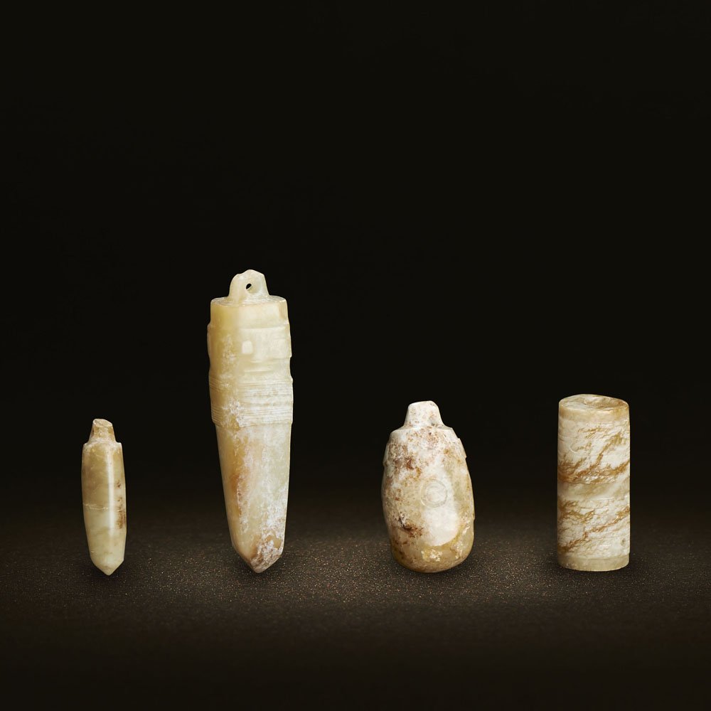 FOUR CHINESE UNEARTHED JADE MASK-FORM PENDANTS (1 of 2)