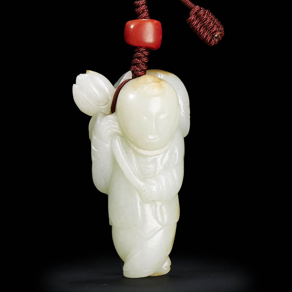 A CHINESE WHITE JADE CARVING OF BOY HOLDING LOTUS (1 of 2)