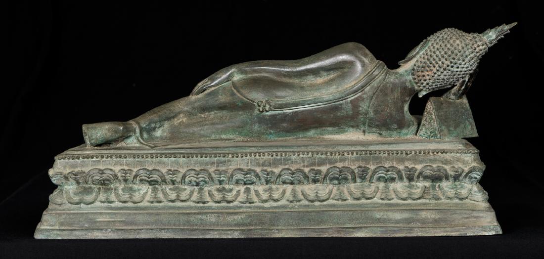 19th Century Sukhothai Reclining Nirvana Buddha: Ca. 19th century Sukhothai nirvana reclining Buddha. The Buddha is laying down on his side in calm repose. This pose captures him in his final moments before his death. The pose is also referred to as