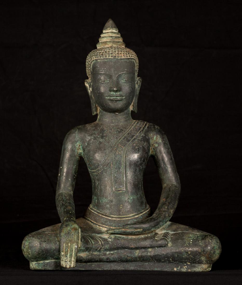 18th Century Khmer Enlightenment Buddha: Ca. 18th century Khmer style Buddha from Cambodia. The Buddha is seated in the Bhumisparsa or 'Calling the Earth to Witness' mudrÄ. With fingers slightly touching the ground this position represents 