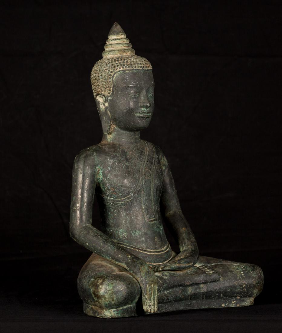 18th Century Khmer Enlightenment Buddha: Ca. 18th century Khmer style Buddha from Cambodia. The Buddha is seated in the Bhumisparsa or 'Calling the Earth to Witness' mudrÄ. With fingers slightly touching the ground this position represents 