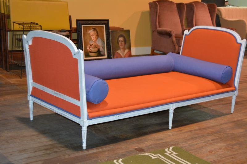 Daybed: Daybed, white wood frame with orange mattress and blue cushions, blue piping trim on orange footboard The daybed is 35"W X 35 1/4"H X 83 1/4"L.